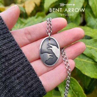 Crows Conversing Oval Pendant